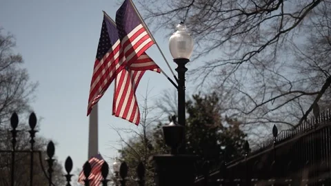 US flags on a post outside the presidents White House in Washington, DC with Stock Footage 305925450