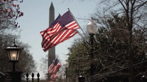 US flags on a post outside the presidents White House in Washington, DC with Stock Footage 306330022