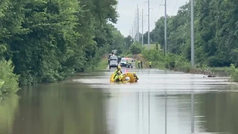 US: Floodwaters Trap SUVs In Fast-Moving Water As Rescuers Launch Swift W... Stock Footage 337676244