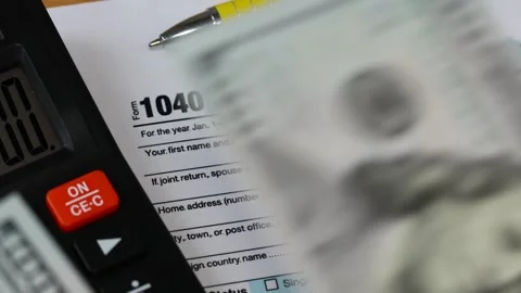 US Form 1040. Tax return and attachments. Financial concept. Stock Footage 319405193