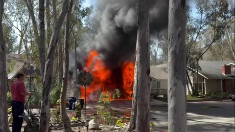 US: Garage Engulfed In Flames As Firefighters Race To Stop Spread In Lake... Stock Footage 335256188