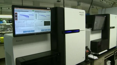 At the U.S. Government's Genome Sequencing Center, DNA is analyzed in the lab. Stock Footage