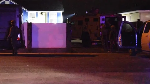 U.S. HSI Special Response Team execute nighttime arrest warrant Stock Footage 300344799