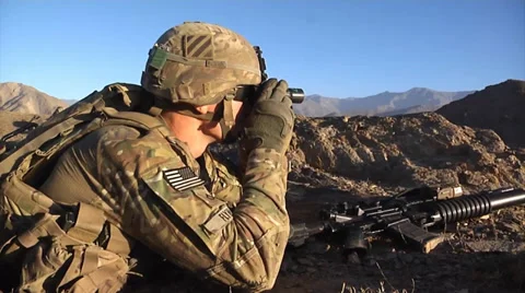 U.S. infantry soldier observing enemy through binoculars Stock Footage 32633298
