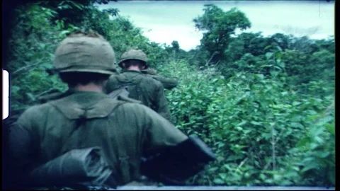 US Infantry Soldiers walking though the jungle with South Vietnam forces. Video stock 82952083
