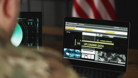 U.S. intelligence officer uploading satellite data on laptops, planning mission Stock Footage 334669228