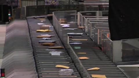 U.S. mail and packages are sorting at a USPS sorting facility. Stock Footage 74957740
