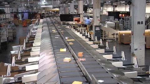U.S. mail and packages are sorting at a USPS sorting facility. Stock Footage 123364122
