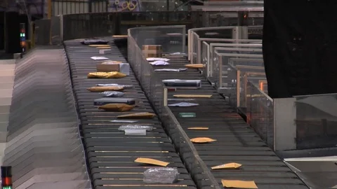 U.S. mail and packages are sorting at a USPS sorting facility. Stock Footage 123377237
