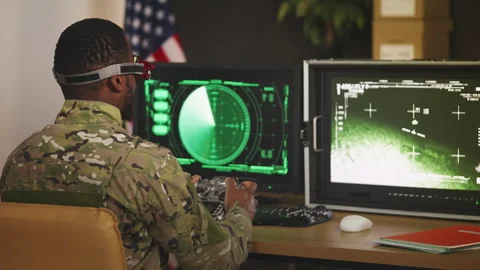 U.S. male FPV drone pilot training in military center with remote controller Stock Footage 335538997