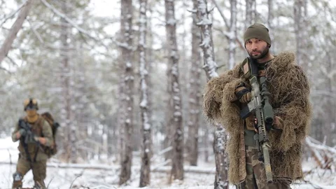 The US Marine Corps is walking through a snowy pine forest. The Masked sniper 스톡 동영상 127956817