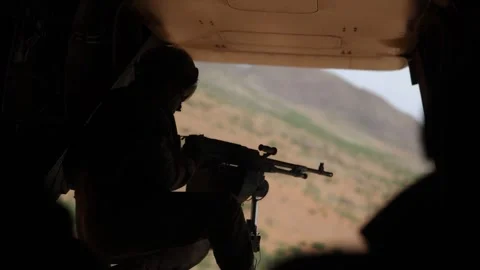 U.S. Marine door gunner looking out from rear ramp Stock Footage 334835385