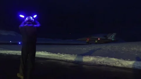 U.S. Marine ground crew using lit marshalling wands at night Stock Footage 265857370
