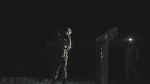 U.S. Marine lifting rucksack onto back at night Video stock 262546226