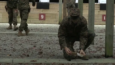U.S. Marine loading magazine clip during pistol training program at Camp Lejeune Stock Footage 82299554