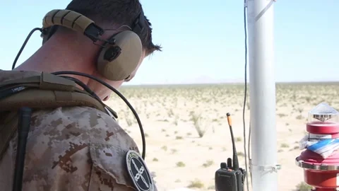 US Marine looking down during Close air support exercise in desert Vídeos de archivo 151251976