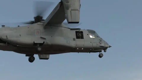 U.S. Marine looking out from the side door of an MV-22 Osprey during flight Video stock 292972176