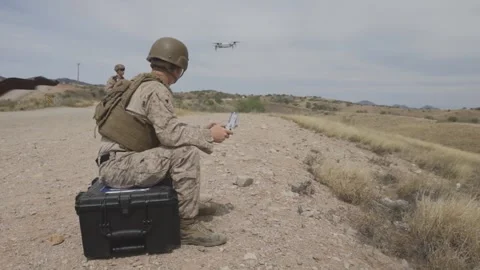 U.S. Marine operates a drone using a handheld remote control console Stock Footage 334841730