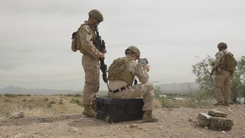 U.S. Marine operates a drone using a handheld remote control console  Stock Footage 334841732