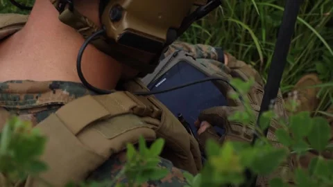 U.S. Marine operating handheld tablet during close air support exercise Stock Footage 210135993
