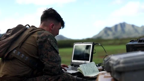 U.S. Marine operating laptop computer during field exercise Stock Footage 261018590