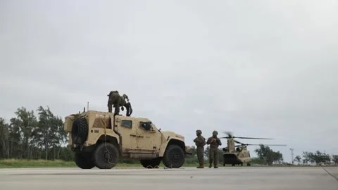 U.S. Marine prepare chains attached to JLTV for external lift Stock Footage 263888179