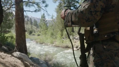 U.S. Marine pulling and unknotting length of rope for river crossing Video stock 277686396