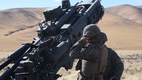 U.S. Marine pulls trigger during artillery training with M777 Howitzer Stock Footage 83579173