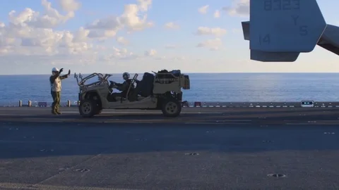 U.S. Marine reversing Utility Task Vehicle onto MV-22 Osprey aboard USS Iwo Jima Video stock 83205933