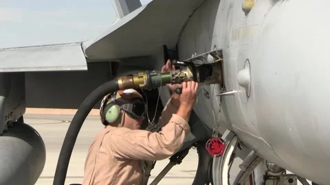 U.S. Marine securing fuel hose nozzle to F/A-18 Hornet during ground refuel Stock Footage 255117723