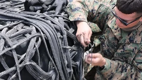 U.S. Marine securing netting to cargo for external lift Stock Footage 277630814