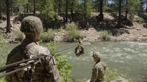 U.S. Marine traversing river on rope  Stock Footage 277686435