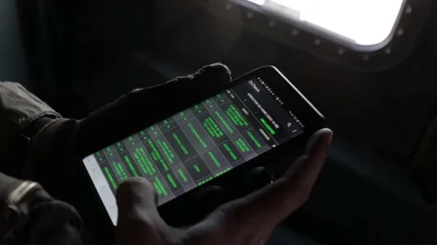 U.S. Marine using application on mobile phone onboard MV-22 Osprey Stock Footage 233256012