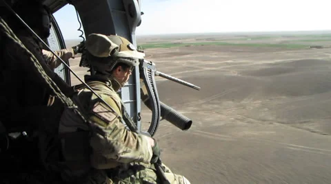 US Marine with weapon sits in open doorway of low altitude helo  (HD) Stock Footage 39153115