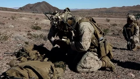 U.S. Marine writing in notebook during platoon attack in the desert Stock Footage 264024516