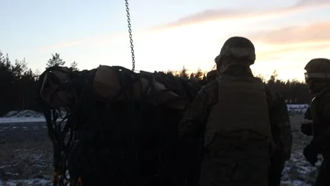 U.S. Marines attach chain to netted cargo during sling load operations Stock Footage 265557541