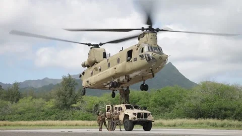 U.S. Marines attaching chains to CH-47 Chinook during sling load operations Stock Footage 263888068