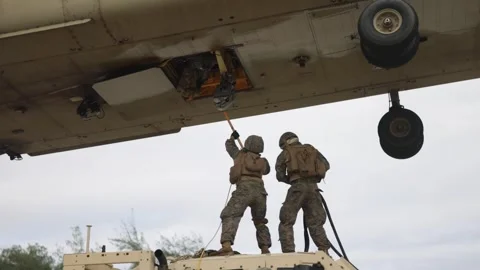 U.S. Marines attaching hook to CH-47 Chinook during sling load operations Stock Footage 263888104