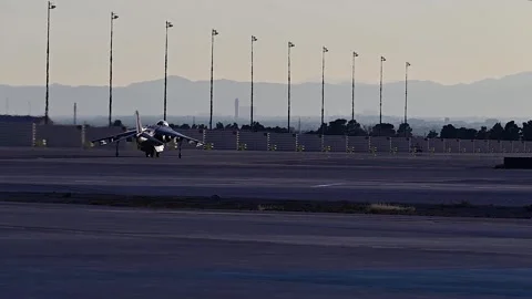 U.S. Marines AV-8B Harrier taxiing at Nellis Air Force Base at dusk Stock Footage 265231649