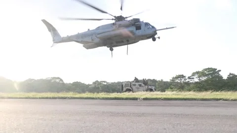 U.S. Marines CH-53 Super Stallion approaches to lift Oshkosh JLTV Video stock 255284196