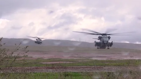 U.S. Marines CH-53 Super Stallion helicopters landing on floodplane Video stock 265422537