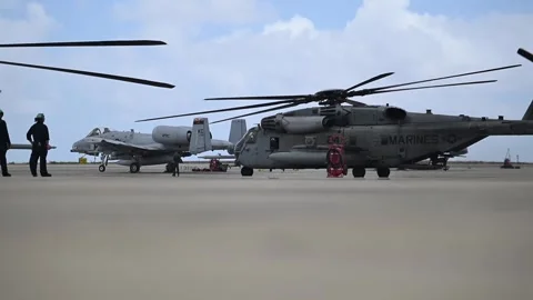 U.S. Marines CH-53 Super Stallion taxiing past U.S. Air Force A-10 Thunderbolt Stock Footage 280658745