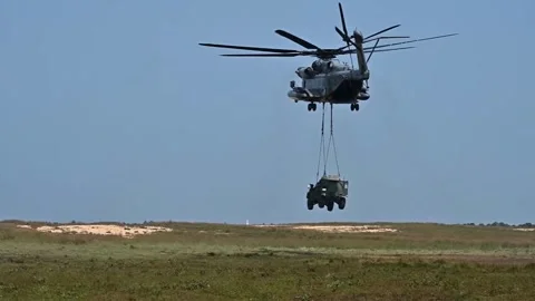 U.S. Marines CH-53 Super Stallion lowering JLTV to ground Stock Footage 282248582