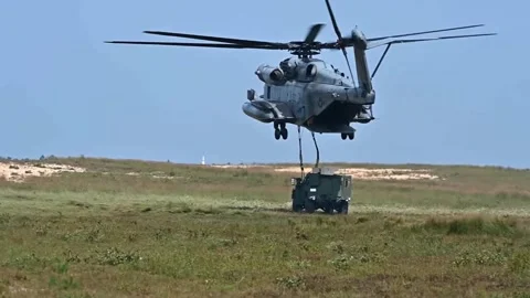 U.S. Marines CH-53 Super Stallion delivering military vehicle by sling load Video stock 282248803
