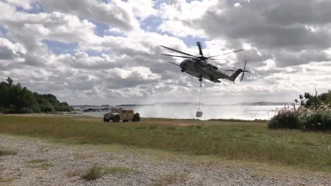 U.S. Marines CH-53 Super Stallion arriving at shoreline with sling load  Video stock 300344737