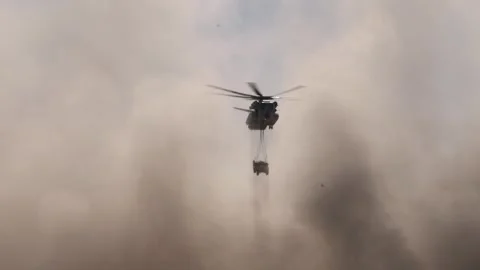 U.S. Marines CH-53 Super Stallion conducting an external lift in sand-storm Stock Footage 300854200