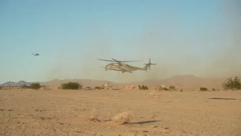 U.S. Marines CH-53E Super Stallion creates sand storm in desert Stock Footage 254402745