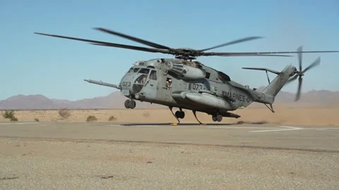 U.S. Marines CH-53E Super Stallion helicopter taking off with chains attached Stock Footage 254402845