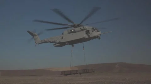 U.S. Marines CH-53K King Stallion helicopter conducting heavy lift in desert Video stock 253998035