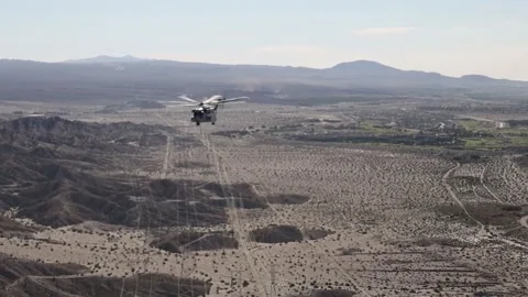 U.S. Marines CH-53K King Stallion flying over desert landscape Stock Footage 254474869